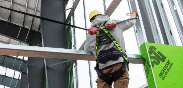 Worker using fall protection gear as a safety precaution he learned in em 385 training