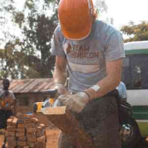 Man cutting wood with a saw.
