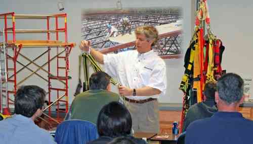 A person teaching an OSHA class in front of an audience