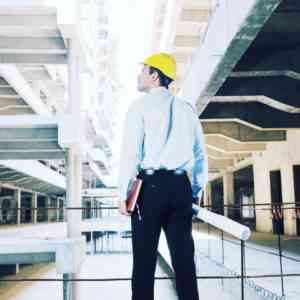 Man in a hardhat standing inside a warehouse